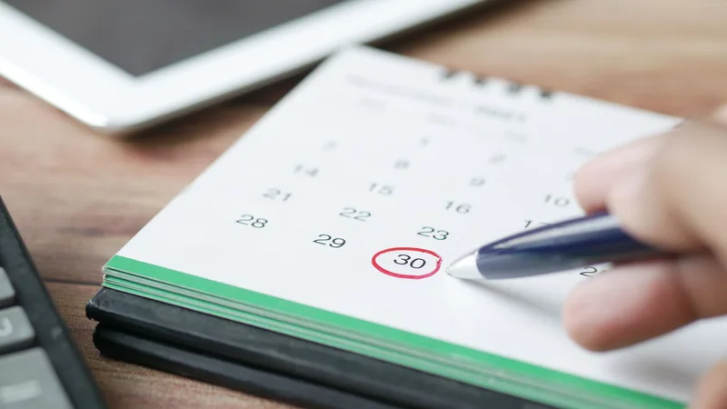 Calendar with day 30 circled pen planning 30-day financial goal