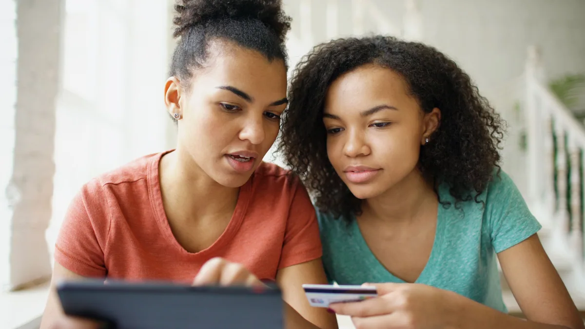 Two women comparing credit card options on tablet together
