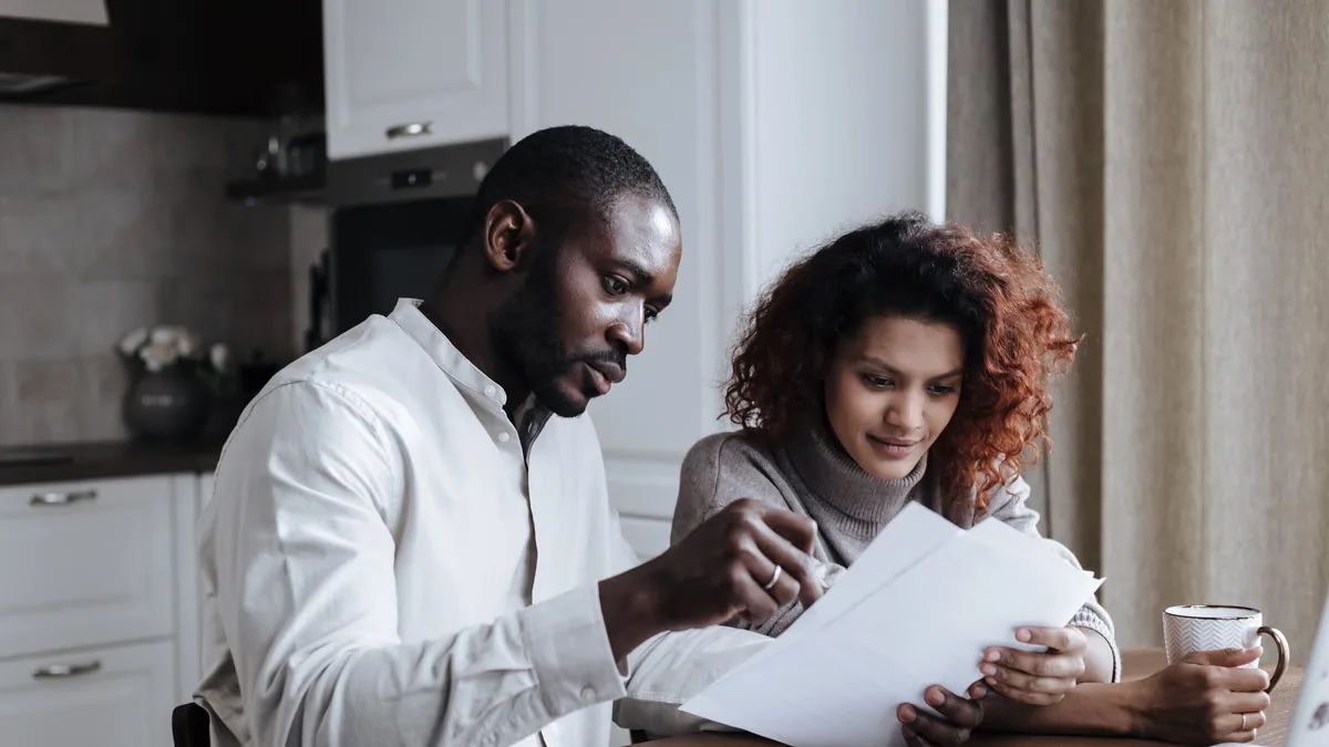 Couple reviewing BrightWay credit card documents at home