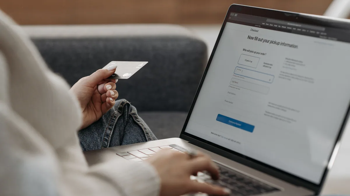 Woman making BrightWay credit card payment online with laptop